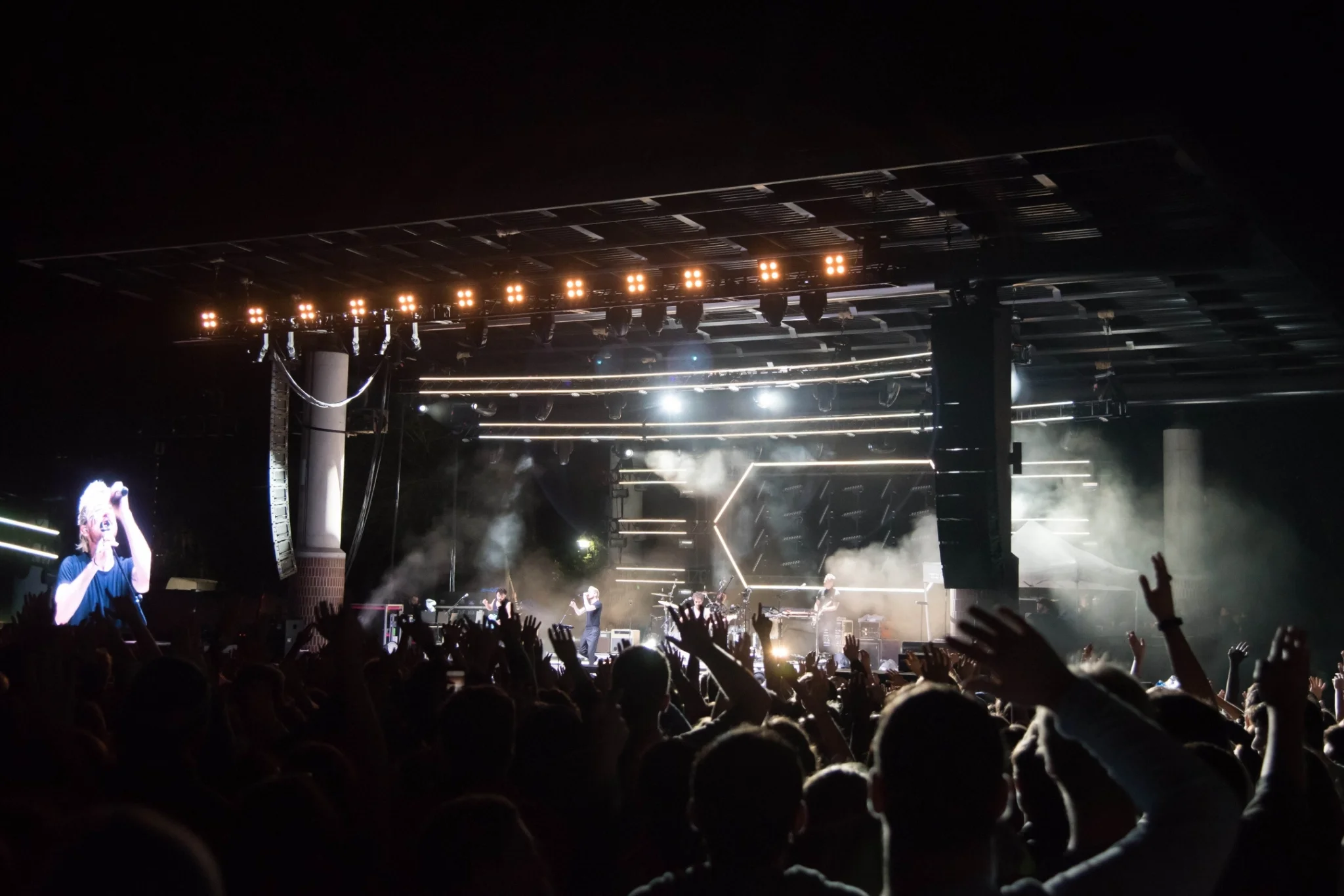 A stage with a crowd of people and stage lights, possibly a concert or performance.