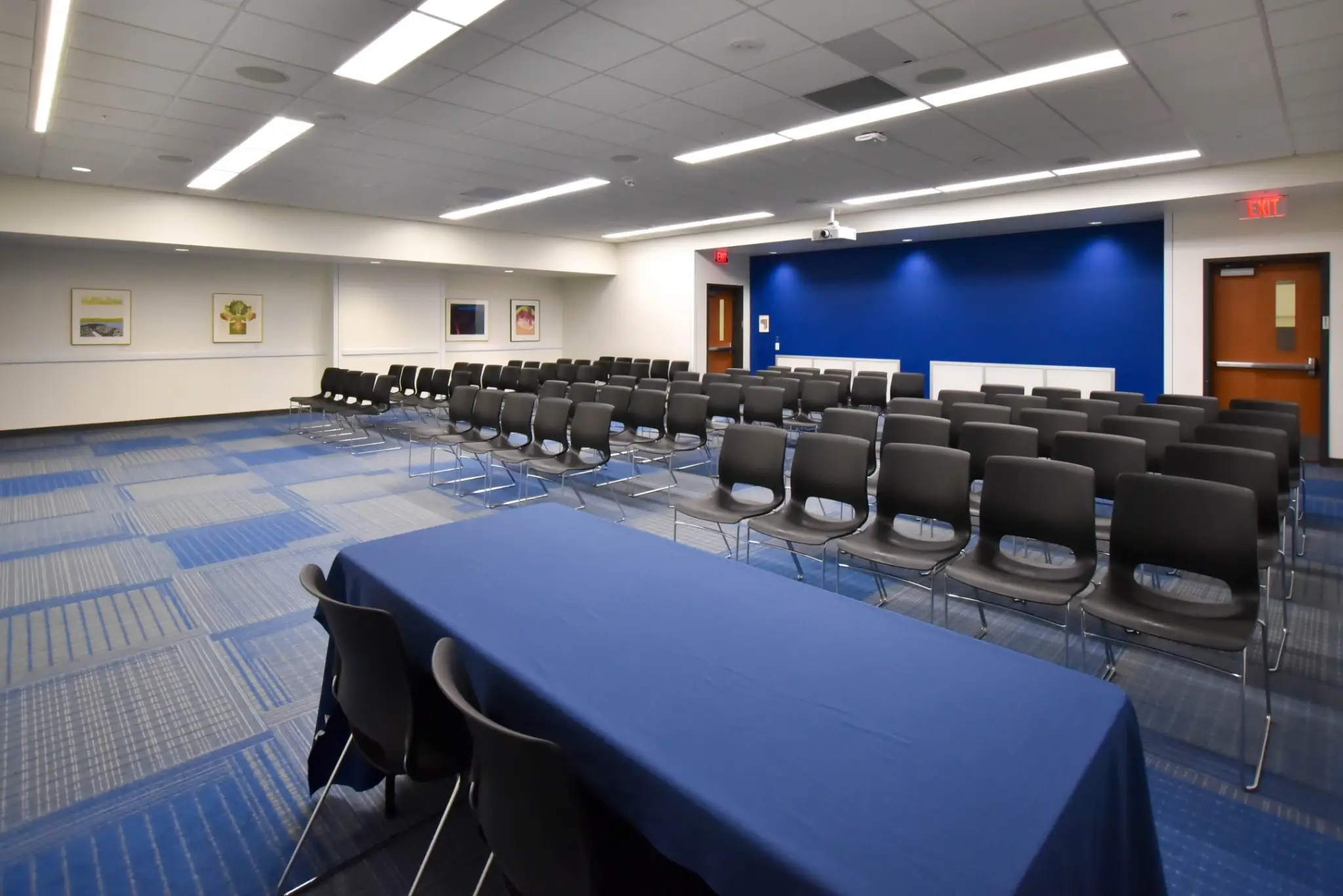 Empty conference room with blue table and chairs.
